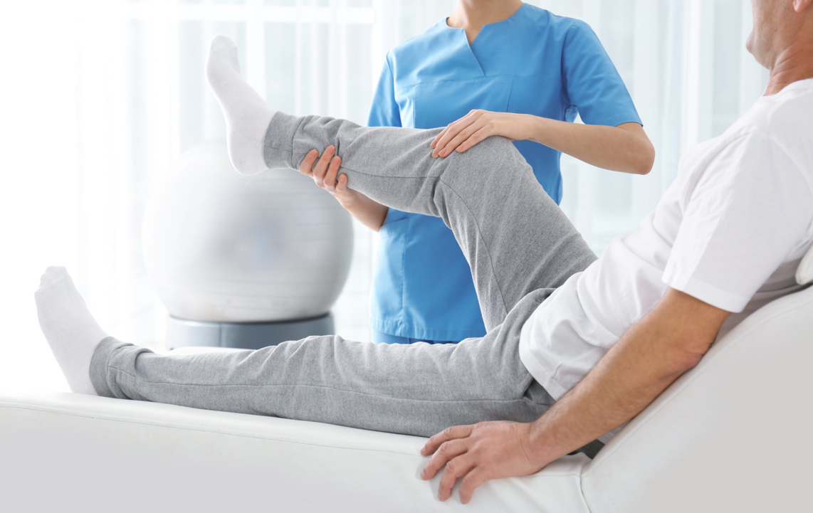 Man receiving physiotherapy to his leg
